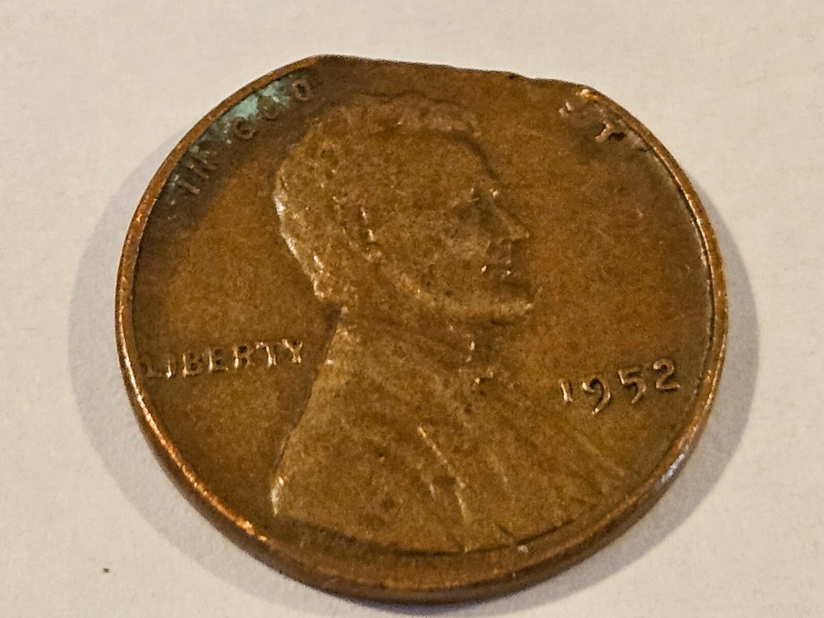 1952 Lincoln Wheat Penny struck on a silver Roosevelt dime planchet showing smaller diameter and partial design